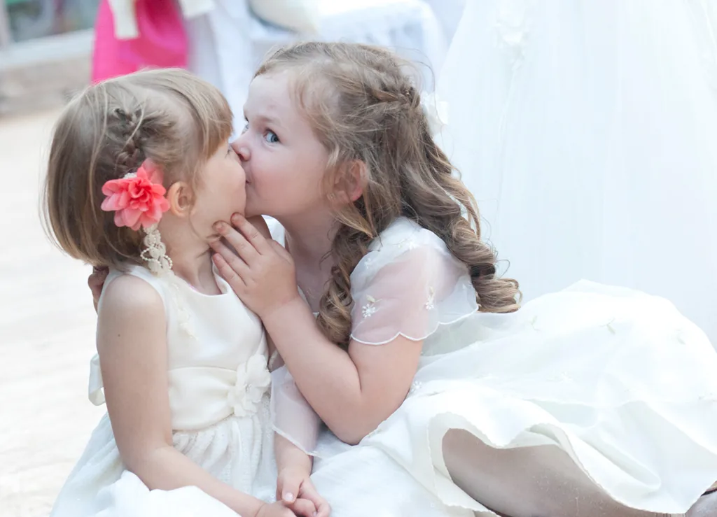 Zwei Blumenmädchen in weißen Kleidern bei einer Hochzeit